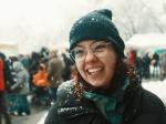 The picture shows Saphir Ben Dakon. She is standing outside in the snow and laughing into the camera.